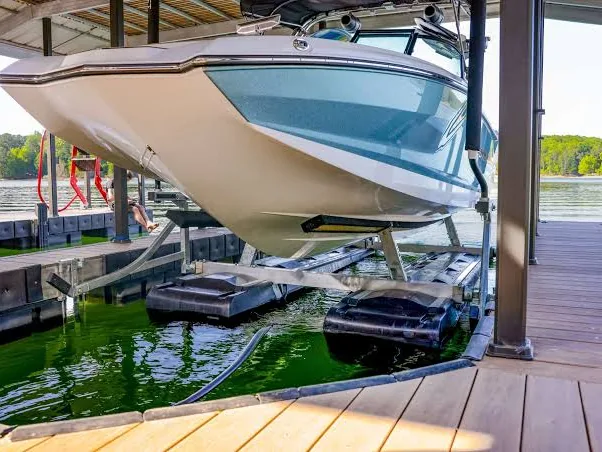 Boat raised on a lift inside a covered slip