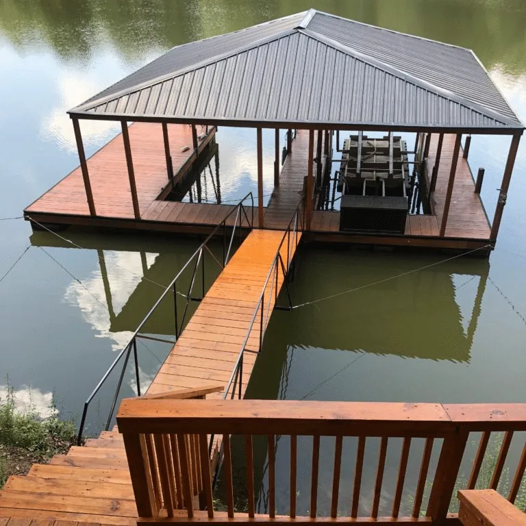 Covered boathouse with a metal roof at the end of a walkway